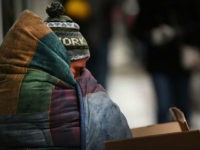 NEW YORK, NY - MARCH 15: A homeless man tries to stay warm on a Manhattan street on an unseasonably cold day on March 15, 2017 in New York City. New Yorkers are getting back to work after a late winter storm brought heavy snow, wind and sleet to the city. Across the city schools and businesses were closed and transportation was severely restricted. (Photo by Spencer Platt/Getty Images)
