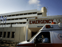 NAHARIYA, ISRAEL - AUGUST 03: An ambulance driver waits in front of the emergency room of the Nahariya hospital August 3, 2006 in Nahariya, Israel. On July 28th a Hezbollah missile landed on the fourth floor crippling a wing of the Nahariya hospital. Patients were moved to its bomb-proof basement for safety and doctors and staff are operating the hospital from there. (Photo by Shaul Schwarz/Getty Images)
