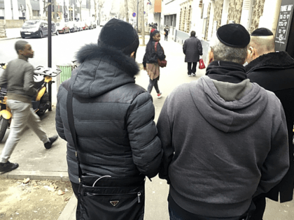 Members of French Jewish community walk in a street of Paris, Wednesday, Feb. 22, 2017. If far-right candidate Marine Le Pen wins the upcoming presidential election, she plans to ban religious symbols from French streets, which would impact on Jews who would no longer be allowed to wear their kippa head-coverings, and Muslims who would no longer be allowed to wear headscarfs in public which may dramatically alter the country's urban landscape. (AP Photo/Jeffrey Schaeffer)