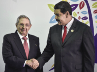 Nicolas Maduro, president of Venezuela, right, and Raul Castro, president of Cuba, shake hands during the Non-Aligned Movement (NAM) Summit in Margarita, Venezuela, on Saturday, Sept. 17, 2016. Venezuela on Tuesday kicked off the the 17th summit of the Non-Aligned Movement on Margarita Island as it attempts to divert attention from the collapse of the nation's economy by preparing to host delegates from countries such as Cuba, Iran, North Korea and Syria. Photographer: Carlos Becerra/Bloomberg via Getty Images