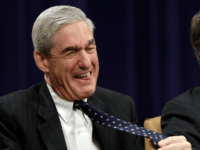 WASHINGTON, DC - AUGUST 01: Outgoing FBI Director Robert Mueller laughs while listening to remarks from former Director of the CIA, George Tenet, during Mueller's farewell ceremony at the Department of Justice August 1, 2013 in Washington, DC. Mueller has served as the Director of the FBI since 2001. (Photo by Win McNamee/Getty Images)