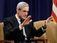 Outgoing FBI Director Robert Mueller (L) is applauded by Deputy Attorny General James Cole (C) and U.S. Attorney General Eric Holder during Mueller's farewell ceremony at the Department of Justice August 1, 2013 in Washington, DC. Mueller has served as the Director of the FBI since 2001. (Photo by Win McNamee/Getty Images)