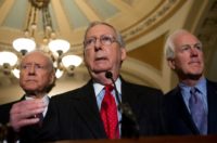 US Senate Majority Leader Mitch McConnell (C) -- shown with fellow Republican Senators Orrin Hatch (L) and John Cornyn (R) -- says he has the votes to pass the tax plan