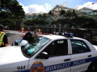 Honolulu police guard road closures around the Convention Center in Honolulu, Hawaii, on November 10 , 2011 during the Asia-Pacific Economic Cooperation (APEC) Summit. The United States hosts this year's APEC forum for the first time since 1993, with leaders from the 21 member economies convening on the island of Oahu. AFP PHOTO Robyn BECK (Photo credit should read ROBYN BECK/AFP/Getty Images)