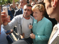 GettyImages-487529794 BERLIN, GERMANY - SEPTEMBER 10: German Chancellor Angela Merkel pauses for a selfie with a migrant after she visited the AWO Refugium Askanierring shelter for migrants on September 10, 2015 in Berlin, Germany. Merkel visited several facilities for migrants today, including an application center for asylum-seekers, a school with welcome …