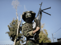 A Palestinian militant from the Ezzedine al-Qassam brigade, the armed wing of Hamas, poses with his weapon while waiting for the arrival of Hamas leader-in-exile Khaled Meshaal in Rafah, southern Gaza Strip, on December 7, 2012. Meshaal is making his first-ever visit to the Gaza Strip amid tight security for festivities marking the ruling Islamist movement's 25th anniversary. AFP PHOTO/MARCO LONGARI (Photo credit should read MARCO LONGARI/AFP/Getty Images)