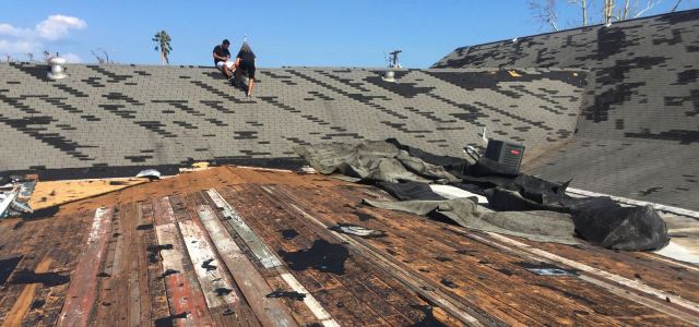 Workers assess damage on roof of First Assembly of God in Rockport, Texas. 
