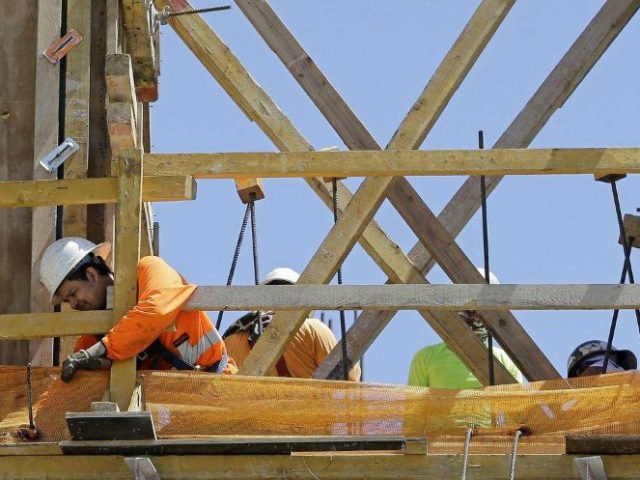 In this Thursday, June 15, 2017, photo, construction workers work on a condominium project in Coral Gables, Fla. On Monday, Oct. 2, 2017, the Commerce Department reports on U.S. construction spending in August. (AP Photo/Alan Diaz)