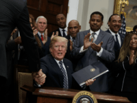 President Donald Trump shakes hands during an event to honor Dr. Martin Luther King Jr., in the Roosevelt Room of the White House, Friday, Jan. 12, 2018, in Washington. (AP Photo/Evan Vucci)