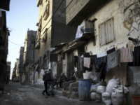 In this Thursday Jan. 11, 2018 photo, Palestinians sit outside their house in the Shati refugee camp in Gaza City. From the Gaza Strip to Jordan and Lebanon, millions of Palestinians are bracing for the worst as the Trump administration moves toward cutting funding to the U.N. agency that assists Palestinian refugees across the region. The expected cuts could deliver a painful blow to some of the weakest populations in the Middle East and risk destabilizing the already struggling countries that host displaced Palestinian refugees and their descendants. (AP Photo/ Khalil Hamra)
