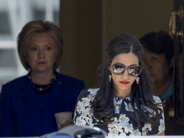 Top Clinton aide Huma Abedin walks ahead of Democratic presidential candidate Hillary Clinton following a private meeting with Sen. Elizabeth Warren, D-Mass., Friday, June 10, 2016, at Clintons home in Washington. The FBI has obtained a warrant to begin reviewing newly discovered emails that may be relevant to the Hillary Clinton email server investigation, a law enforcement official told The Associated Press. FBI investigators want to review emails of longtime Clinton aide Huma Abedin that were found on a device seized during an unrelated sexting investigation of Anthony Weiner, a former New York congressman and Abedins estranged husband. (AP Photo/J. Scott Applewhite)