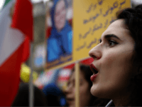 Demonstrators of the National Council of Resistance of Iran protest near the Iran's embassy in Paris, Saturday, Jan. 6, 2018, in solidarity with those demonstrating in Iran. Iran has seen its largest anti-government protests since the disputed presidential election in 2009, with thousands taking to the streets in several cities in recent days. (AP Photo/Christophe Ena)