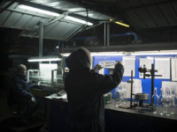 In this Wednesday, Jan. 27, 2016 photo, an employee checks the quality of glass bottles on the production line at Phoenicia Glass Works Ltd. factory in the southern Israeli town of Yeruham. Phoenicia Glass Works, Israel’s only glass container factory, produces one million containers a day. Some 300,000 bottles a day come out with defects, and the factory grinds them into shards and piles them in a desert lot to be melted into new bottles. The factory is in the middle of the desert, and works round the clock, every day of the year. (AP Photo/Oded Balilty)