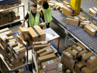 In this Dec. 2, 2013 file photo, Amazon.com employees organize outbound packages at an Amazon.com Fulfillment Center on 