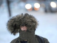 Kasim Kantarevic, 12, keeps his hood up as he walks to school on Thursday, Dec. 15, 2016 in Erie, Pa. Much of the northern Mid-Atlantic and Northeast will stay cold for the next couple of days as the arctic air remains stuck over the northern Appalachians, the National Weather Service said. (Christopher Millette/Erie Times-News via AP)