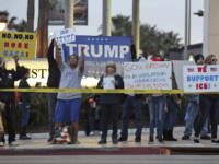 Opponents of demonstrators urging the Democratic Party to protect the Deferred Action for Childhood Arrivals Act (DACA) stand outside the office of California Democratic Sen. Dianne Feinstein in Los Angeles Wednesday, Jan. 3, 2018. California has the largest number of people who are affected by the law, also known as the Dream Act.(AP Photo/Reed Saxon)