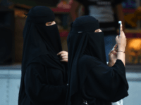 Women walk on Tahlia street in the Saudi capital Riyadh on September 24, 2017, during celebrations for the anniversary of the founding of the kingdom. / AFP PHOTO / Fayez Nureldine (Photo credit should read FAYEZ NURELDINE/AFP/Getty Images)