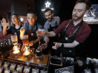 In this Wednesday, March 22, 2017, file photo, baristas from Starbucks' specialized coffee shop, Reserve Roastery, demonstrate a siphon brew of individual cups of coffee before the company's annual shareholder meeting in Seattle. Starbucks is giving its U.S. workers pay raises and stock bonuses in 2018, citing recent tax reform. The coffee chain is also extending the potential to earn paid sick time off to all employees, and is boosting its parental leave benefits. (AP Photo/Elaine Thompson, File)