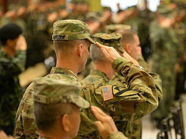 US soldiers salute as their national anthem is played during the opening ceremony of the annual joint 11-day Balikatan (Shoulder-to-Shoulder) military exercise in Manila on April 4, 2016. US and Philippine troops began major exercises on April 4 as China's state media warned 'outsiders' against interfering in tense South China Sea territorial disputes. / AFP / TED ALJIBE (Photo credit should read TED ALJIBE/AFP/Getty Images)