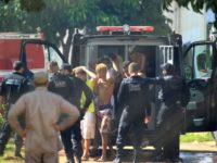 Inmates who escaped during a riot at a Brazilian prison, the Complejo de Aparecida in Goias state, are seen being returned by guards in this photo released by Brazilian newspaper O Popular