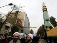 Iranians gather next to a replica of a Ghadr medium-range ballistic missile during a demonstration outside the former US embassy in the Iranian capital Tehran on November 4, 2017