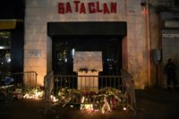 Candles, flowers and messages at a makeshift memorial around the commemorative plaque outside the Bataclan concert hall