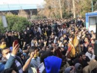 In this photo taken by an individual not employed by the Associated Press and obtained by the AP outside Iran, university students attend a protest inside Tehran University while anti-riot Iranian police prevent them to join other protestors, in Tehran, Iran, Saturday, Dec. 30, 2017. A wave of spontaneous protests over Iran's weak economy swept into Tehran on Saturday, with college students and others chanting against the government just hours after hard-liners held their own rally in support of the Islamic Republic's clerical establishment. (AP Photo)