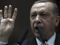 Turkey's President and leader of ruling Justice and Development Party Recep Tayyip Erdogan addresses his lawmakers at the parliament in Ankara, Turkey, Tuesday, Jan. 16, 2018. Erdogan on Tuesday called on NATO to take a stance against the United States, a fellow ally, over its plans to form a 30,000-strong Kurdish-led border security force in Syria. Turkey has been threatening to launch a new military offensive in Syria against Syrian Kurdish militias, which Turkey considers to be terrorists because of their affiliation with outlawed Kurdish rebels fighting Turkey.(AP Photo/Burhan Ozbilici)