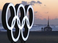 A visitor walks along the beach near the Olympic Rings in Gangneung, South Korea, Wednesday, Jan. 24, 2018. Gangneung is the site of the coastal cluster which will host ice hockey, figure skating, speedskating, short track and curling for the 2018 Olympics. The 2018 Pyeongchang Games will be held from Feb. 9 to 25. (AP Photo/Lee Jin-man)