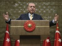 Turkey's President Recep Tayyip Erdogan addresses local administrators in Ankara, Turkey, Wednesday, Jan. 24, 2018. Erdogan says Turkey's incursion into a Kurdish-held enclave in Syria is progressing "successfully" and will continue until the last "terrorist" is eliminated. (Murat Cetinmuhurdar/Pool Photo via AP)