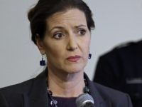 FILE - In this May 13, 2016 file photo, Oakland Mayor Libby Schaaf, left, speaks beside then-Oakland Chief of Police Sean Whent in Oakland, Calif. The teenage daughter of a police dispatcher at the center of a Northern California sexual misconduct scandal involving two dozen officers has filed suit against one of the law enforcement agencies, her attorney announced Friday, Aug. 18, 2017. The 19-year-old filed the federal lawsuit in San Francisco Thursday, Aug. 17, 2017. Whent was forced to resign in June 2016 and the department cycled through two other chiefs in less than a month before the city's top administrator took over management of the police. (AP Photo/Ben Margot, File)