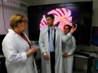 German Chancellor Angela Merkel, doctor Hans Fried and Eleonora Ambrad talk inside the new research center for dementia diseases DZNE at the university hospital in Bonn, Germany, on March 15, 2017.