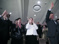 In this photo provided by South Korea Presidential Blue House, South Koran President Moon Jae-in, right, waves as North Korea's nominal head of state Kim Yong Nam, left, Kim Yo Jong, North Korean leader Kim Jong Un's sister, and Hyon Song Wol, second from left, leader of North Korea's Samjiyon Orchestra, applaud after a performance of North Korea's Samjiyon Orchestra at National Theater in Seoul, South Korea, Sunday, Feb. 11, 2018. A rare invitation to Pyongyang for South Korea's president marked Day Two of the North Korean Kim dynasty's southern road tour, part of an accelerating diplomatic thaw that included some Korean liquor over lunch and the shared joy of watching a 