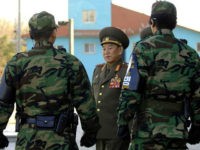 North Korea's chief delegate Kim Yong-Chol (C) walks by South Korean soldiers after the inter-Korean general talks at the south side of the truce village of Panmunjom, in the Demilitarized Zone, 14 December 2007. High-level military talks between North and South Korea ended without agreement on a proposed joint fishing area to avert clashes. AFP PHOTO/POOL/JUNG YEON-JE (Photo credit should read JUNG YEON-JE/AFP/Getty Images)