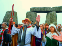 SALISBURY, ENGLAND - DECEMBER 22: Druids, pagans and revellers gather in the centre of Stonehenge, hoping to see the sun rise, as they take part in a winter solstice ceremony at the ancient neolithic monument of Stonehenge near Amesbury on December 22, 2017 in Wiltshire, England. Despite a forecast for cloud and rain, a large crowd gathered at the famous historic stone circle, a UNESCO listed ancient monument, to celebrate the sunrise closest to the Winter Solstice, the shortest day of the year. The event is claimed to be more important in the pagan calendar than the summer solstice, because it marks the 're-birth' of the Sun for the New Year. (Photo by Matt Cardy/Getty Images)