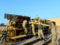 AFRIN, SYRIA - FEBRUARY 23: Turkish soldiers carry rockets, produced with local means, as they make preparations to hit PKK/KCK/PYD-YPG and Deash terror group targets with them via missile batteries, can launch 40 rockets in 80 seconds with 40 kilometers long range even bad weather conditions, on the border line within the 'Operation Olive Branch' launched in Syria's Afrin, on February 23, 2018. Turkey launched Operation Olive Branch on January 20 in Syrias northwestern Afrin region; the aim of the operation is to establish security and stability along Turkish borders and the region as well as to eliminate PKK/KCK/PYD-YPG and Daesh terror groups, and protect the Syrian people from the oppression and cruelty of terrorists. (Photo by Soner Kilinc/Anadolu Agency/Getty Images)