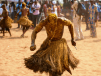A Voodoo devotee in a trance performs at the annual Voodoo Festival on January 10, 2017 in Ouidah. Officially declared a religion in Benin in 1996, Voodoo and the Voodoo festival attracts thousands of devotees and tourists for a day filled with ritual dances and gin drinking. Benins voodoo festival is held every year and is the West African countrys most vibrant and colourful event. / AFP / STEFAN HEUNIS (Photo credit should read STEFAN HEUNIS/AFP/Getty Images)