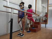 In this Oct. 16, 2015 photo, amputee victims in Nepal's massive 2015 earthquake, Nepalese girls Khendo Tamang, left, and Nirmala Pariyar, both 8, practice walking with new prosthetic legs at a clinic in Kathmandu, Nepal. Spending months together with surgeries and the following physical therapy, both girls were soon inseparable in the and relied on their friendship to help ease the emotional wounds. (AP Photo/Niranjan Shrestha)