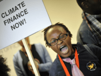 A climate activist shouts slogans during a demonstration at the Bella Center of Copenhagen on December 16, 2009 during the COP15 UN Climate Change Conference. AFP PHOTO / ATTILA KISBENEDEK (Photo credit should read ATTILA KISBENEDEK/AFP/Getty Images)