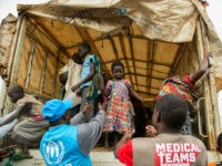 Congolese people who crossed the border from the Democratic Republic of Congo arrive at the Nyakabande transit centre to be registered as refugees in the village of Nyakabande in western Uganda on January 24, 2018. Since Last December, Congolese people, about 300 people per day, have been fleeing from the Mai Mai militias attacks in the Kivu region of the eastern part of DRC to this border area. / AFP PHOTO / SUMY SADURNI / The erroneous mention appearing in the metadata of this photo by SUMY SADURNI has been modified in AFP systems in the following manner: NYAKABANDE instead of Nteko. Please immediately remove the erroneous mention from all your online services and delete it from your servers. If you have been authorized by AFP to distribute it to third parties, please ensure that the same actions are carried out by them. Failure to promptly comply with these instructions will entail liability on your part for any continued or post notification usage. Therefore we thank you very much for all your attention and prompt action. We are sorry for the inconvenience this notification may cause and remain at your disposal for any further information you may require. (Photo credit should read SUMY SADURNI/AFP/Getty Images)