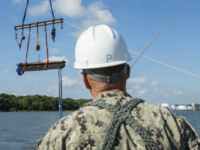 In a Friday, Aug. 14, 2015 photo provided by the US Navy, Chief Warrant Officer 3, Jason Potts, on scene commander for Task Element CSS Georgia, supervises as a piece of casemate, made of railroad ties and timber, which served as the outer layer of armor for CSS Georgia, is raised from the Savannah River in Savannah, Ga. Navy divers are working in conjunction with archeologists, conservationists, Naval History and Heritage Command and the U.S. Army Corps of Engineers in a project directed by Naval Sea Systems Command Supervisor of Salvage and Diving to salvage and preserve CSS Georgia. (MC1 Blake Midnight/US Navy via AP)