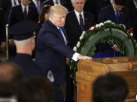 President Donald Trump touches the casket of Rev. Billy Graham as he lies in honor in the U.S. Capitol Rotunda, Wednesday, Feb. 28, 2018 in Washington. (Chip Somodevilla/Pool via AP)