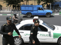 Iranian police control the scene in front of the British Embassy in Tehran prior to arrival of the British Foreign Secretary Philip Hammond to reopen the Embassy, Iran, Sunday, Aug. 23, 2015. Iran's state TV says British Foreign Secretary Philip Hammond has reopened the British Embassy in Tehran nearly four years after it closed following an attack by hardliners. Hammond's visit is the first by a British foreign secretary to Iran since 2003. (AP Photo/Ebrahim Noroozi)