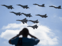 In this file photo taken on Saturday, Aug. 12, 2017 a man watches Russian military jets performing in Alabino, outside Moscow, Russia. The Russian military says major war games, the Zapad (West) 2017 maneuvers, set for next month will not threaten anyone. (AP Photo/Pavel Golovkin, File)