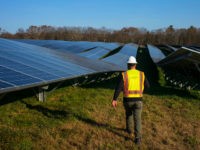 GRAFTON, MASSACHUSETTS - DECEMBER 4: Employees from a Radian Generation's operations and maintenance team change out a faulty solar inverter along a row of solar panels December 4, 2017 at the family-owned Knowlton Farm in Grafton, Massachusetts. The 3.7 megawatt solar array is owned and operated by BlueWave Solar which feeds the generated electricity to homes and small businesses in nearby municipalities. (Photo by Robert Nickelsberg/Getty Images)