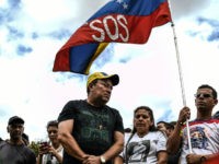 CEMENTERIO DEL ESTE, CARACAS, MIRANDA, VENEZUELA - 2018/02/12: A venezuelan flag with SOS printed on it seen at the cemetery. Remembrance service held in Caracas in honor of those killed during the protests in Venezuela. Group of people marched to the eastern cemetery with relatives of the victims who have died protesting since 2014. (Photo by Román Camacho/SOPA Images/LightRocket via Getty Images)