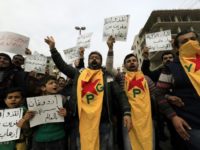 Syrian Kurds march in the northern Syrian city of Afrin during a February 4, 2018 demonstration against the Turkish-led military assault on the enclave