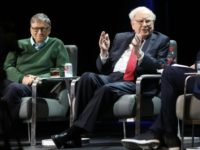 Investor Warren Buffett, seen here speaking at an event early last year in New York with fellow billionaire Bill Gates, says in his new newsletter that his company received a $29 billion bonus in 2017 thanks to a new US tax law
