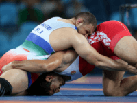 Turkey's Taha Akgul, right, competes against Iran's Komeil Nemat Ghasemi, left, during the men's 125-kg freestyle wrestling gold medal match at the 2016 Summer Olympics in Rio de Janeiro, Brazil, Saturday, Aug. 20, 2016. (AP Photo/Petr David Josek)