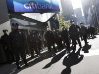 New York City police officers stand guard outside a Citibank branch as protestors associated with the Occupy Wall Street movement march in midtown Manhattan to deliver letters to bank CEOs at their corporate headquarters, Friday, Oct. 28, 2011, in New York. (AP Photo/Mary Altaffer)